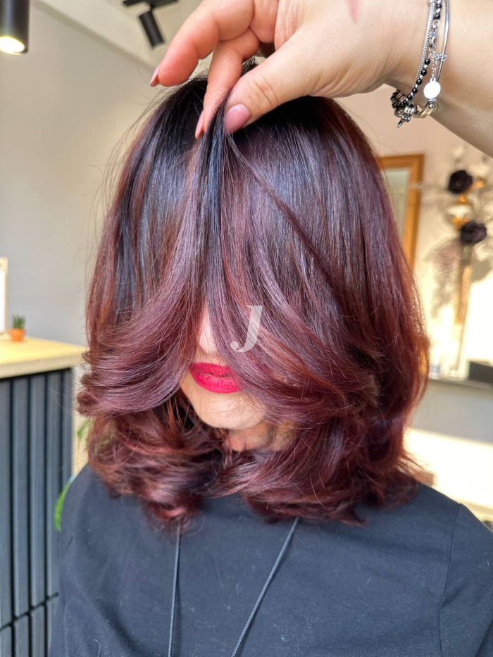 Foto di donna con capelli medi castano scuro mogano o violino